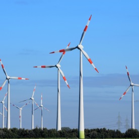 ein Windpark mit vielen Windenergieanlagen ist zu sehen vor blauem Himmel