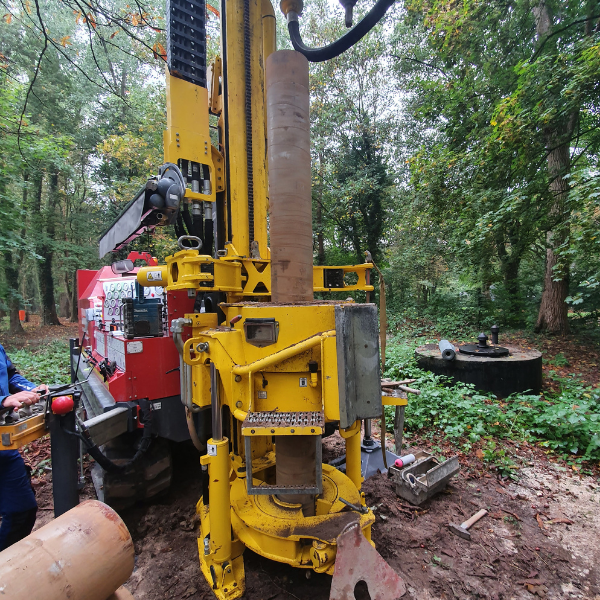 Bohrmaschine im Einsatz in einem bewaldeten Gebiet.